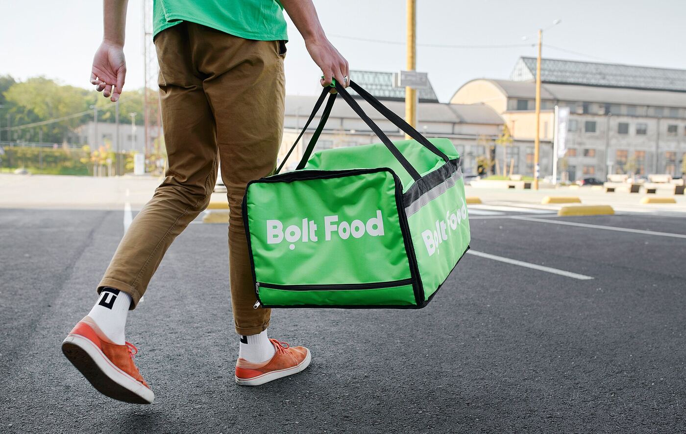 A delivery courier carrying an insulated food bag