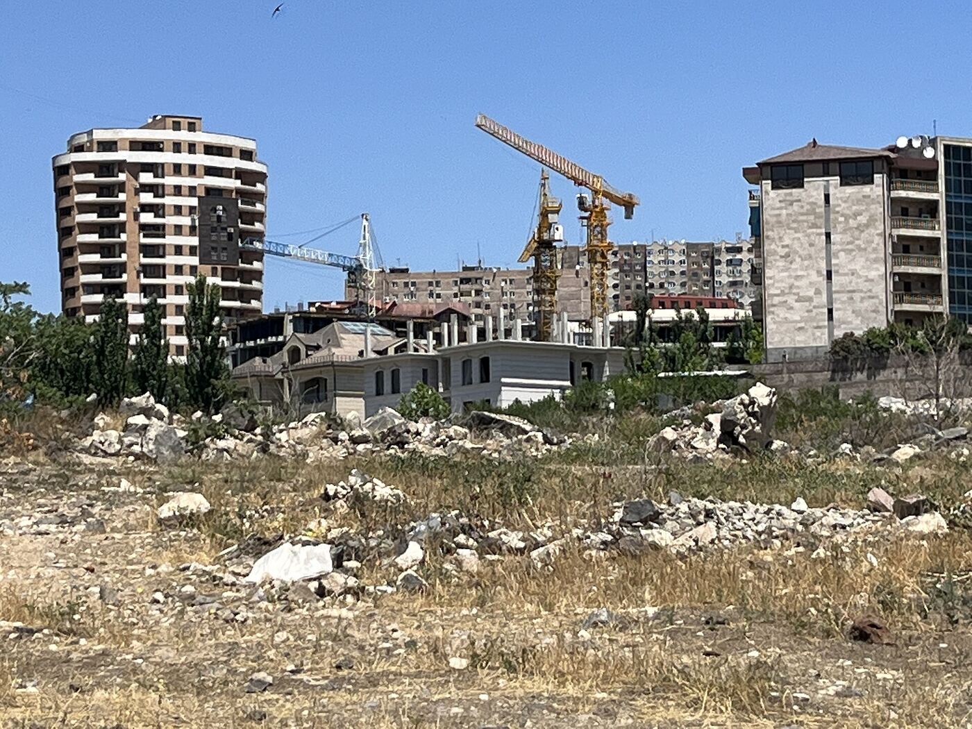 Apartment buildings under construction with tower cranes in Yerevan